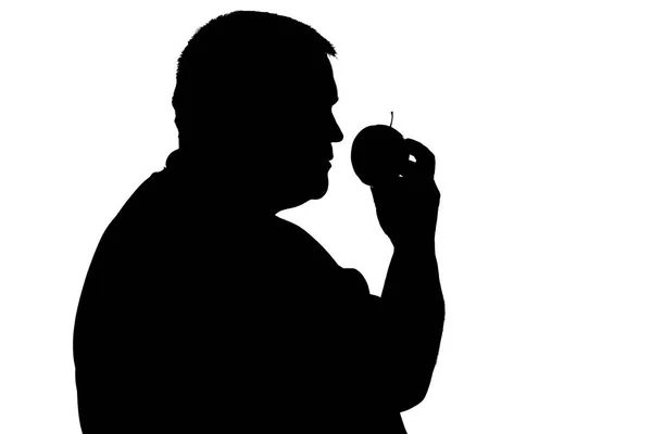Silueta de un hombre con sobrepeso con una manzana en la mano — Foto de Stock