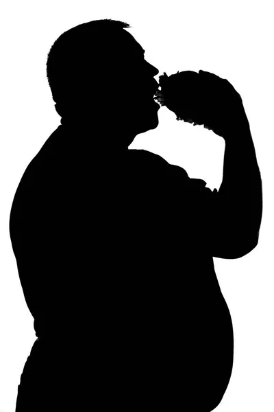 Silhouette d'un homme qui mange des aliments malsains — Photo