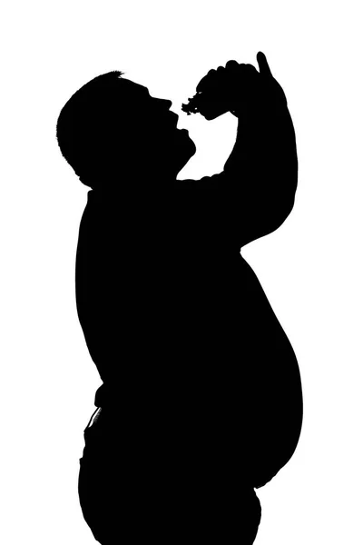Sziluettjét a férfiak, az elhízás, aki eszik egy hamburgert — Stock Fotó