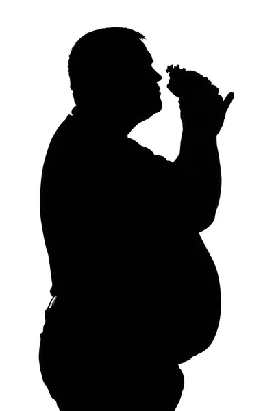 Silhouette di uomini con obesità che mangiano un hamburger — Foto Stock