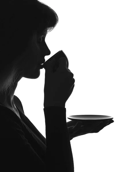 Silhouette portrait of woman drinking hot coffee — Stock Photo, Image