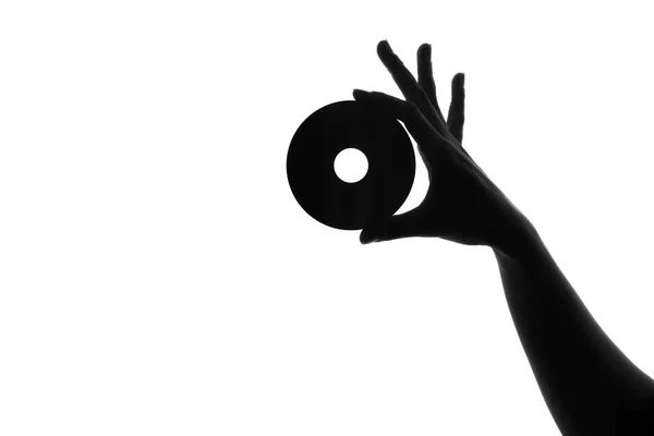 Silhouette of a female hand with a disk — Stock Photo, Image