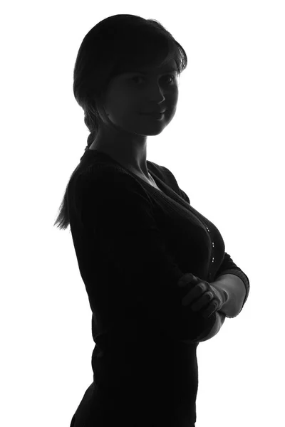 Silhouetteof a female with her arms folded over her chest — Stock Photo, Image