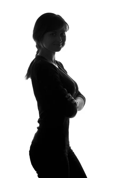 Silhouetteof a female with her arms folded over her chest — Stock Photo, Image