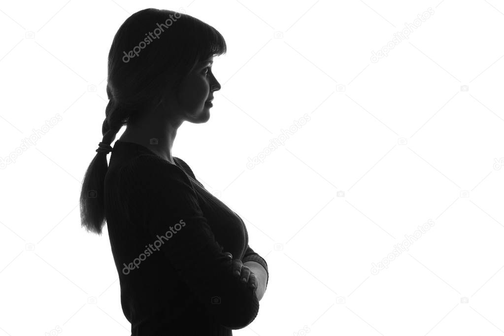 silhouetteof a female with her arms folded over her chest