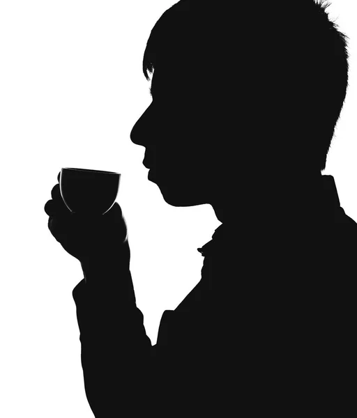 Silhouette of a man drinking coffee — Stock Photo, Image