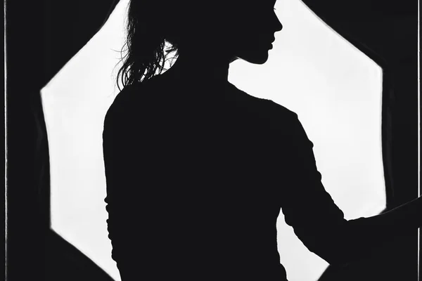 Silhouette of a model posing in a photo studio