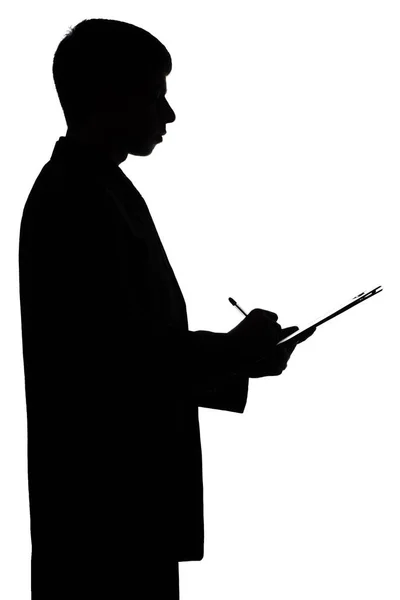 Silhouet van een zakenman met de ondertekening van een document — Stockfoto