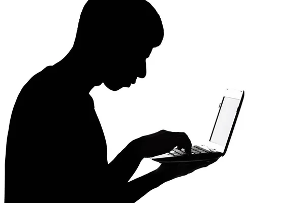Silhouette of a man with netbook stealing information — Stock Photo, Image