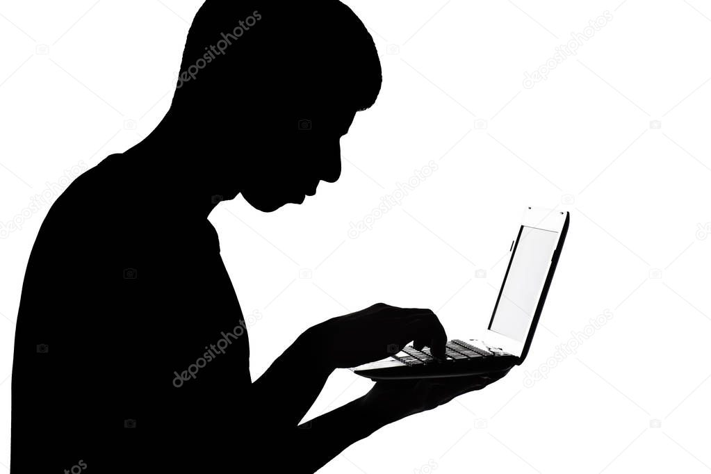 Silhouette of a man with netbook stealing information