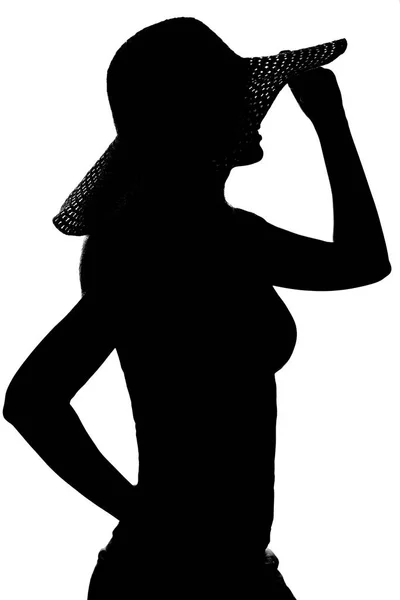 Silhouette di una donna con un cappello — Foto Stock