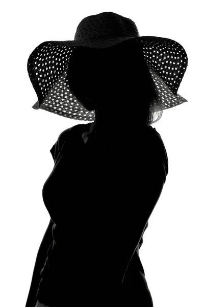 Silhouette di una donna con un cappello — Foto Stock