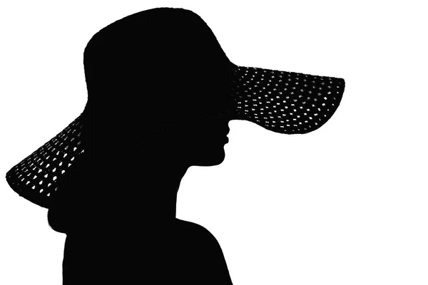 Silhouet van een vrouw die haar gezicht onder een hoed verbergen — Stockfoto