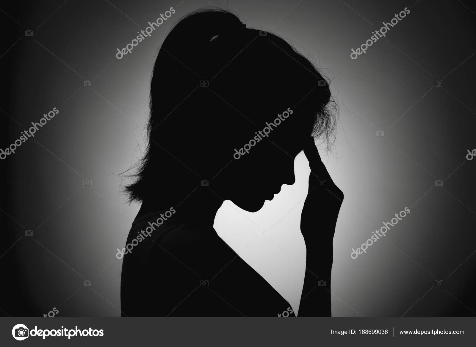 Silhouette of the girl face profile of an unrecognizable sad, woman in  depression put her hand to forehead Stock Photo by ©fantom_rd 168699036