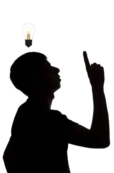 Silhouette of an unknown man who dawned on an idea on a white isolated background, concept thought light bulb — Stock Photo, Image