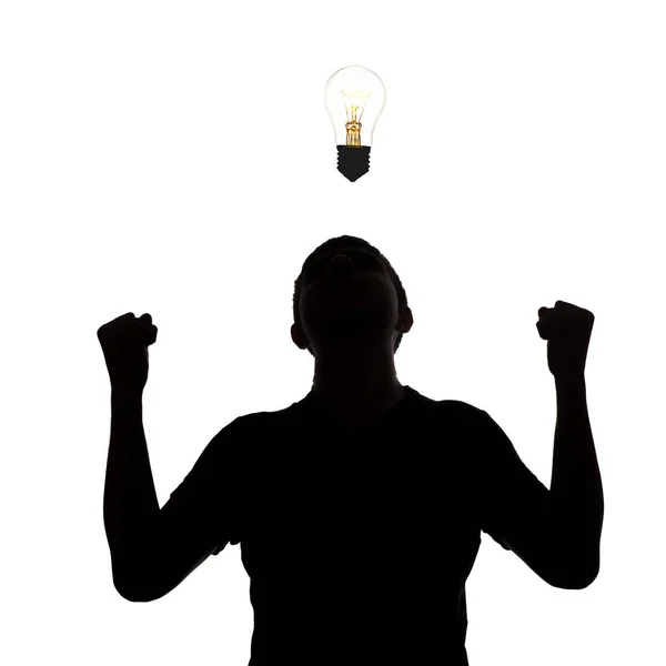 Silhouette of an unknown man who dawned on strong idea on a white isolated background, concept thought light bulb, emotions of joy and victory — Stock Photo, Image