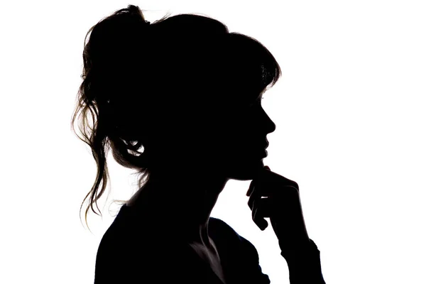 Silhouette of a thoughtful beautiful girl with hand near her chin thinking about solving a problem on white isolated background — Stock Photo, Image