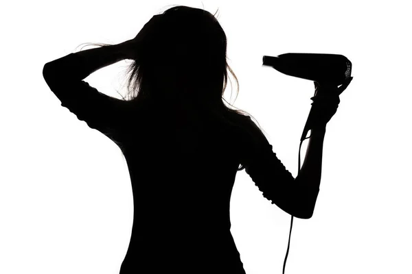 Silhouet van een vrouw doet kapsel met haar drye, concept — Stockfoto