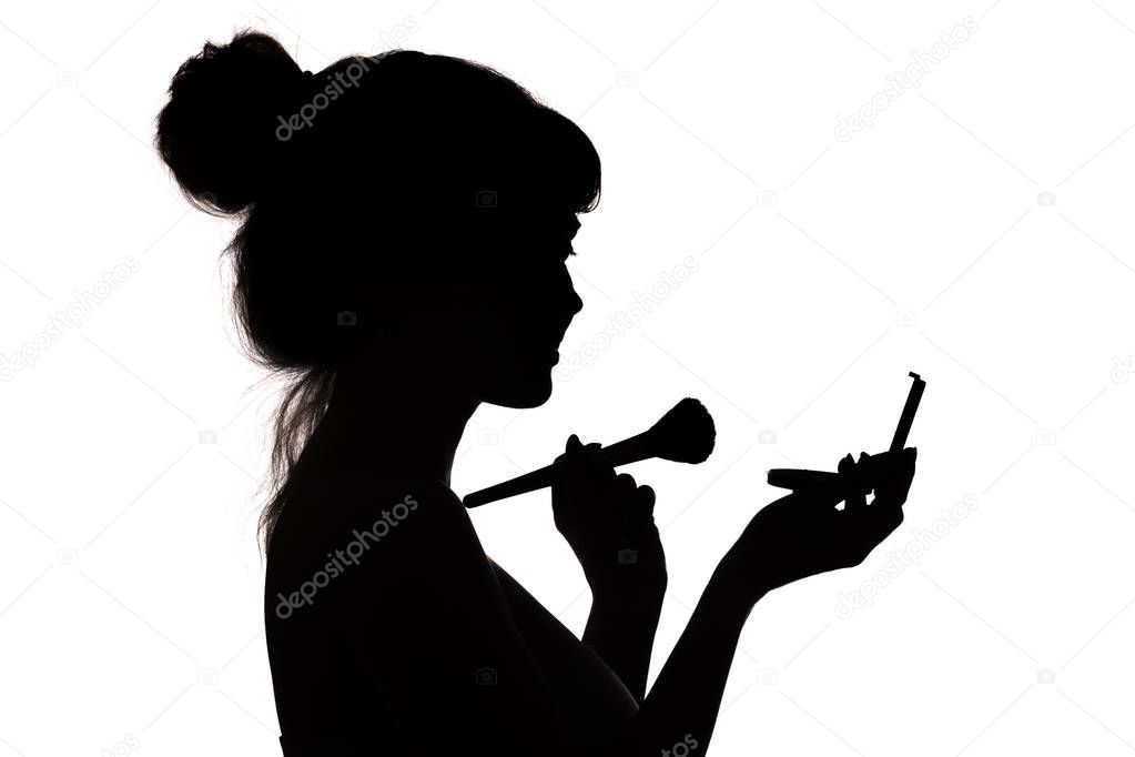 silhouette of girl doing make-up, profile of woman face on white isolated background, concept of fashion and beauty
