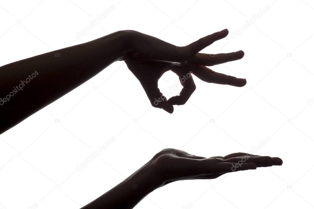 silhouette of female hands kicking something off on isolated white background
