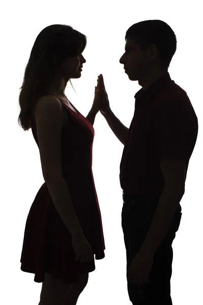 Silhouette of a young male and female in love on white isolated background, man touch hands of woman, concept romance — Stock Photo, Image