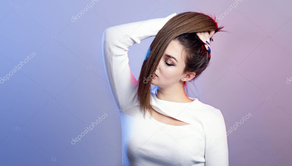 portrait of cocky teenager girl with long ponytail hair on studio background, young woman with character, fashion model, female beauty