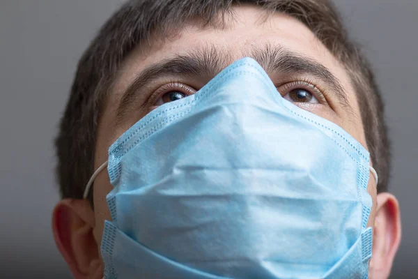 head of doctor in surgical mask ready to operate and looking straight with confidence, concept of medicine and health,head of doctor in surgical mask ready to operate in hospital ward, man looking straight with confidence, concept of medicine and hea