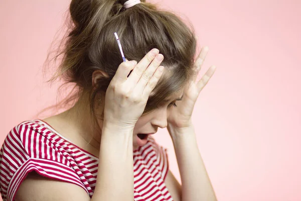 Беспокойная Молодая Женщина Смотрящая Одноразовый Медицинский Тест Беременность Розовом Фоне — стоковое фото