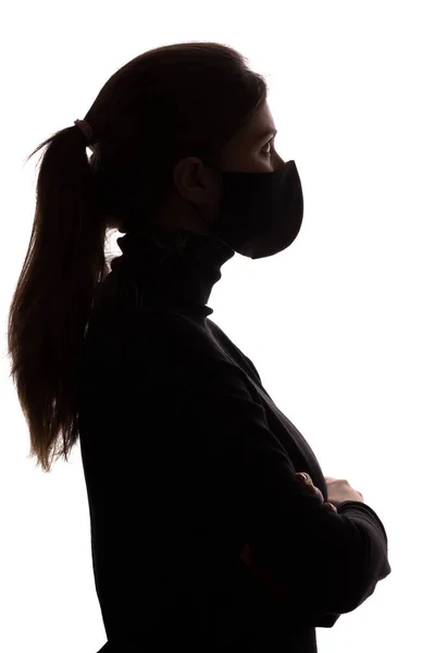 Stüdyonun Arka Planında Koruyucu Maskeli Genç Bir Kadının Siluet Profili — Stok fotoğraf