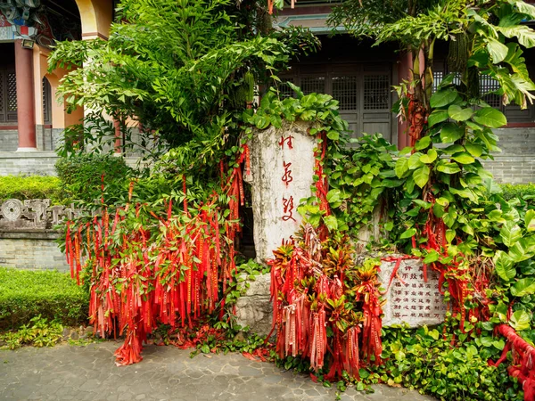 Red ribbons on a wishing tree at a Chinese temple in Hainan, Chi