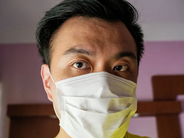 Asian Chinese man / person wearing a surgical face mask as prote Royalty Free Stock Photos