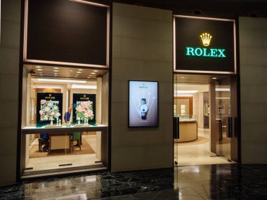 Singapur Tatil Köyü 'nde yüz maskesi takan 2020 Çinli turist. Resort World logosu arka planda görünür.
