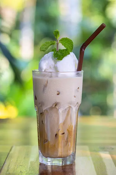 Glass of Thai Coffee smoothie topping with whip cream