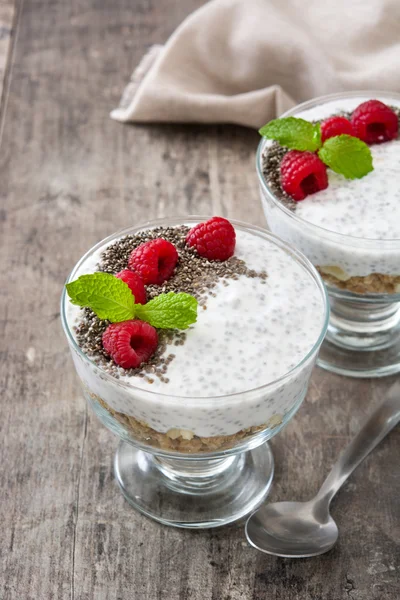 Chia yogurt with raspberries in a glass cup on wooden table — Stock Photo, Image