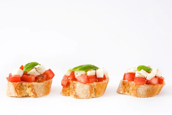 Caprese salad bruschettas isolated on white background — Stock Photo, Image