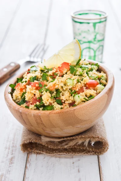 Tabbouleh salad with couscous on a white table — Stock Photo, Image