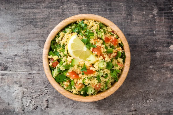 Tabbouleh salad with couscous on a rustic table — Stock Photo, Image