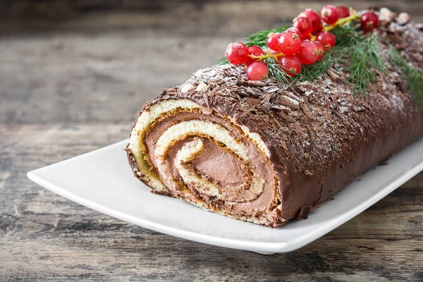 A fából készült háttér piros ribizli torta csokoládé yule log — Stock Fotó