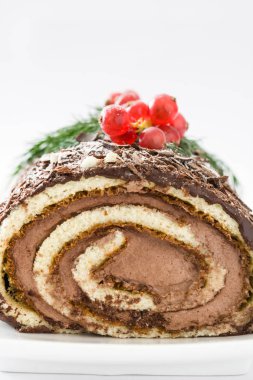Çikolata yule log Noel Kek ile beyaz arka plan üzerinde izole kırmızı kuş üzümü
