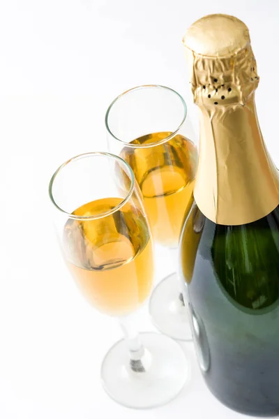 Champagne bottle and cups isolated on white background Stock Picture
