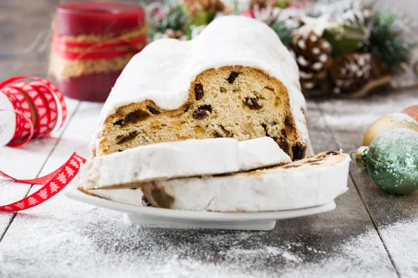 Christmas stollen. Traditional German Christmas dessert on wooden background — Stock Photo, Image