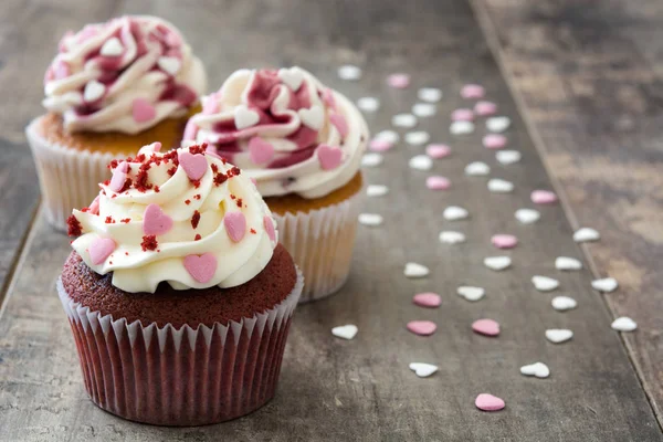 Valentine cupcakes decorated with sweet hearts on wooden table — Stock Photo, Image