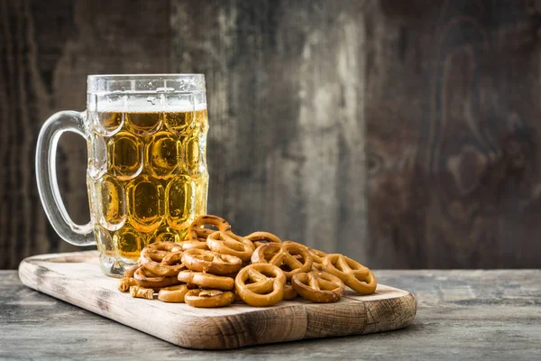 Pretzels and beer on wooden table