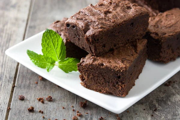 Porce Čokoládové brownie na dřevěné pozadí — Stock fotografie