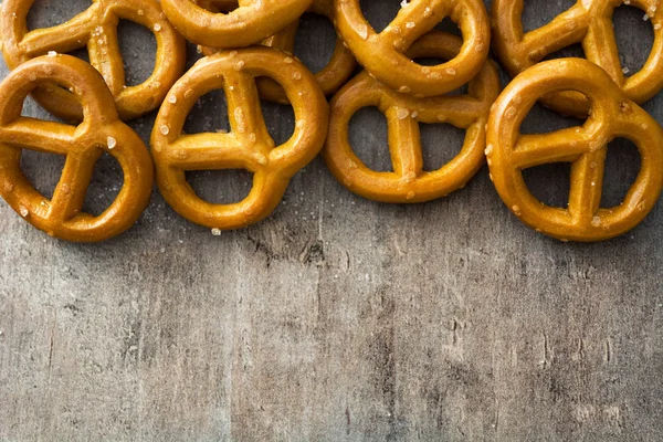 Salted pretzels on wooden background — Stock Photo, Image