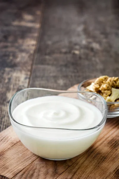 Řecký jogurt v míse na dřevěný stůl — Stock fotografie