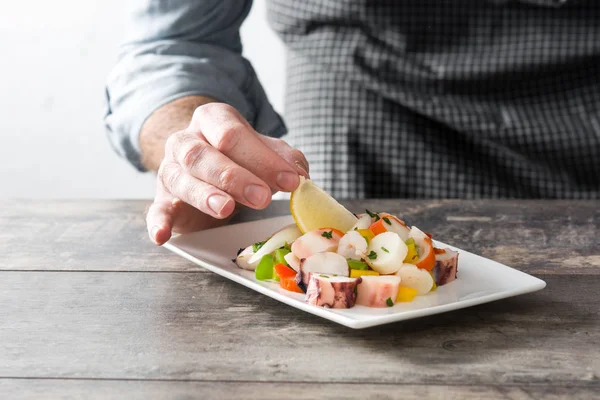 Chef preparing seafood ceviche on wooden table — Stock Photo, Image