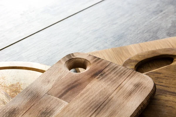 Cutting boards on wooden background — Stock Photo, Image