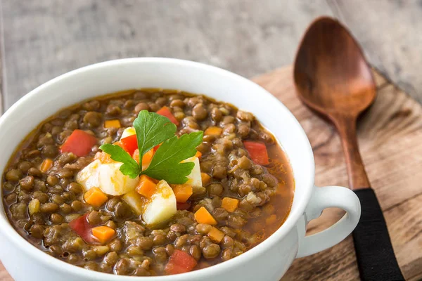Lentil soup in a bowl on wooden background — Stock Photo, Image
