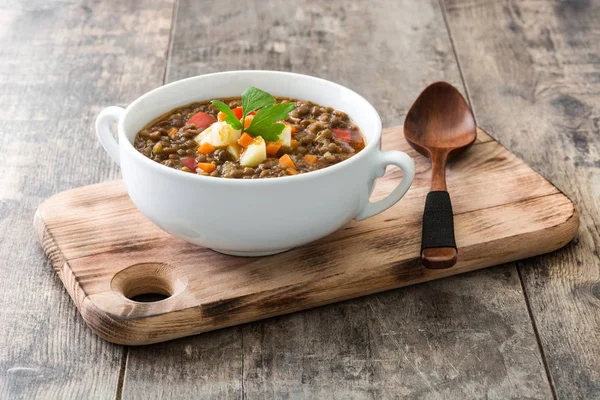 Lentil soup in a bowl on wooden background — Stock Photo, Image